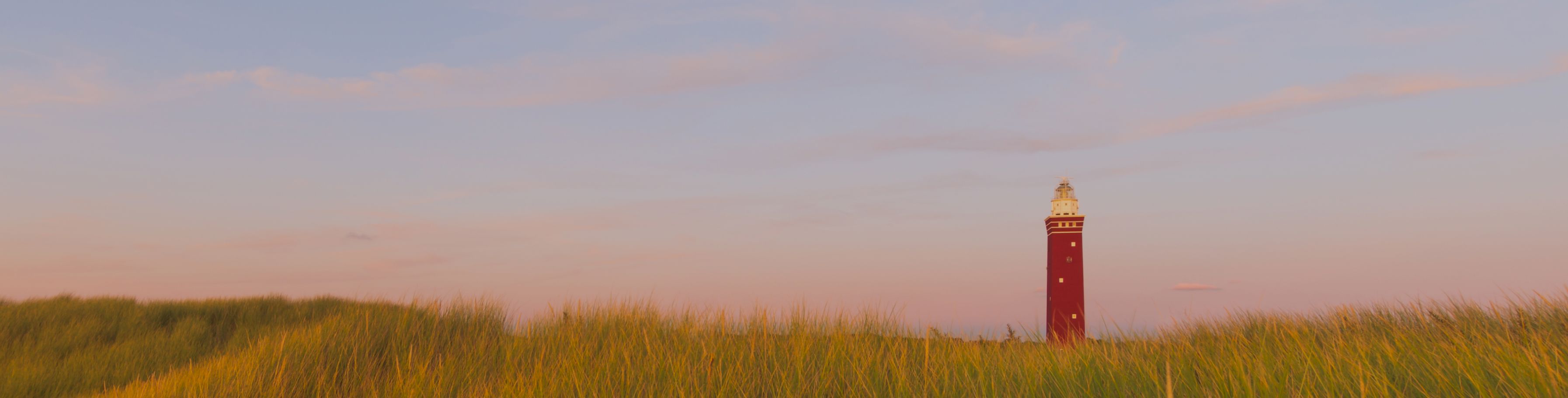 Beautiful Shot Grassy Field With Red Lighthouse Distance Blue Sky 2